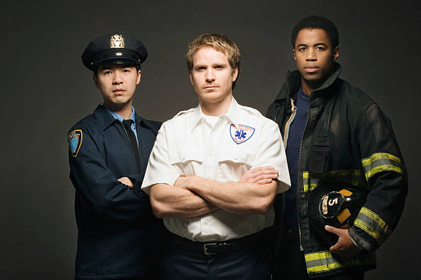 Police officer, paramedic, and fireman on black background, portrait 第一响应者